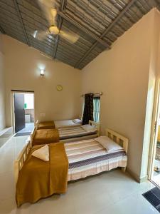 a bedroom with two beds in a room at RAC Adventure Camp by Lexstays,Near Isha Foundation in Chik Ballāpur
