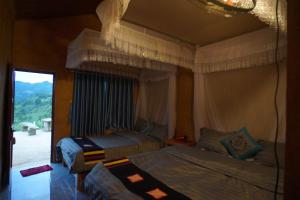 Cette chambre comprend 2 lits et une fenêtre. dans l'établissement Lý Thị Chương Homestay & Bungalow, à Bản Kam