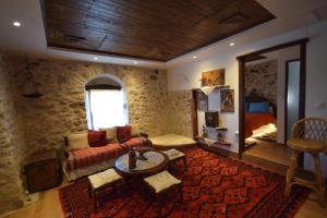 a living room with a couch and a table at Irini's studios in Zigovístion