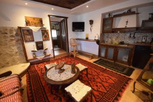 a living room with a couch and a table at Irini's studios in Zigovístion