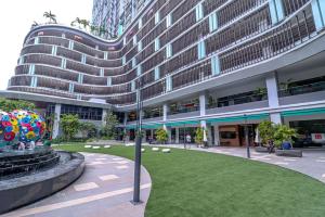 a large building with a lawn in front of a building at 10 min to My town family unit By Nexx Field in Kuala Lumpur
