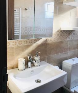 a bathroom with a sink and a toilet at Apartmani SOVA in Novi Pazar