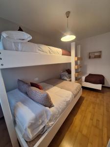 two bunk beds in a room with wooden floors at TERRAZA DEL VELETA junto a CARD in Sierra Nevada