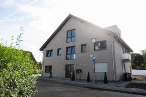 a large brick building on the side of a street at HAMA Design Homes Pader-Lounge in Paderborn