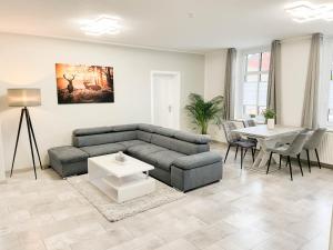 a living room with a couch and a table at Alte Försterei 2.0 in Thale