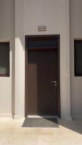 a door in a building with a sign above it at Hawana salalah Apartment Mimosa in Salalah