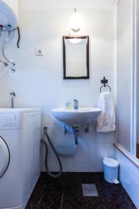 a bathroom with a sink and a mirror at Lavender apt. w. balcony in old town in Zadar