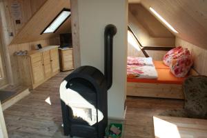 a wood stove in a room with a bed at Ferienwohnung Nicklich in Berbisdorf