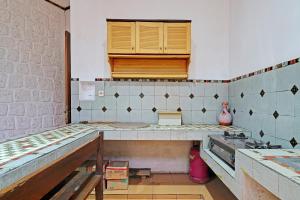 a kitchen with a sink and a counter top at OYO Life 92589 Geusan Ulun Residence in Bandung