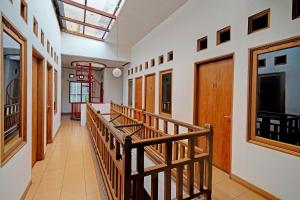 a hallway with a wooden staircase and a skylight at OYO Life 92589 Geusan Ulun Residence in Bandung