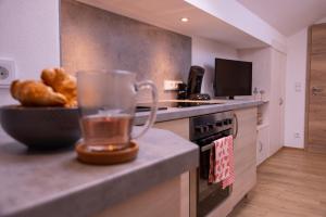 a kitchen with a blender on a counter with a bowl of bread at Ferienwohnung Zum Wiesle in Krün +10 photos