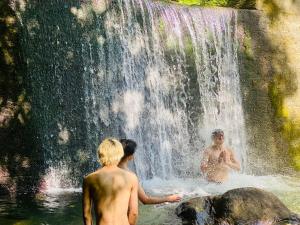 zwei Personen, die vor einem Wasserfall stehen in der Unterkunft Vanguard Backpackers in Sagamihara