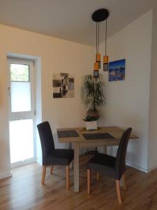 a dining room with a table and two chairs at One Apartment in Salzburg