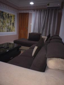 a living room with a couch and a table at ANGELA HOME in Douala