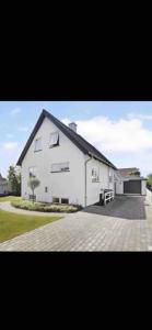 a large white house with a large driveway at Happy Fisherman BnB in Aalborg