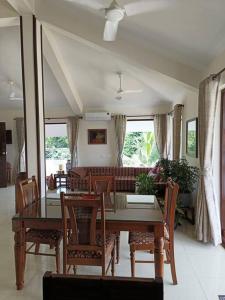 a dining room with a table and chairs and a couch at Casa Do Mundo - Your Holiday Home in Porvorim