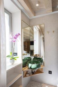 a bathroom with a green sink and a mirror at Spirito Santo Palazzo Storico in Rovinj