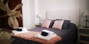 a bedroom with a bed with towels on it at Sunhouse in Playa Honda