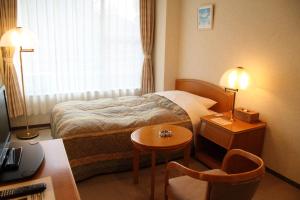 Postel nebo postele na pokoji v ubytování 有馬 瑞宝園 + 2 fotografie