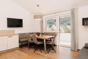 a kitchen and dining room with a table and chairs at Ferienappartement Bergliebe in Grossarl