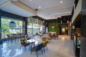 une salle à manger avec des tables et des chaises dans un restaurant dans l'établissement Subic Riviera Hotel & Residences, à Kababae