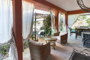 a patio with wicker chairs and a table at Borgo Caere in Ladispoli