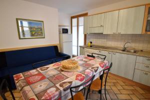 a kitchen with a table with a table cloth on it at Excelsior Central Apartment in Madonna di Campiglio