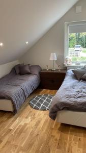 a bedroom with two beds and a window at Charmig apartens in à house in stockholm in Stockholm