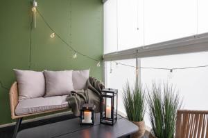 a living room with a couch and a table at Arctic Golden Sun City Suite in Rovaniemi