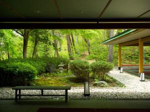 a bench sitting in front of a garden at Jodogahama Park Hotel in Miyako