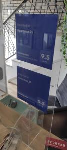 a blue sign on top of a desk with a mouse at Apartman 25 in Belgrade