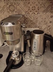 a coffee maker and two glasses on a counter at Les Acacias - Maison Orly in Orly