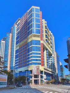 a large building with many windows in a city at Centum Business Hotel in Busan