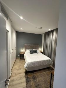a bedroom with a large white bed in a room at Oceans Lux 1 Bedroom - Seaview in Durban