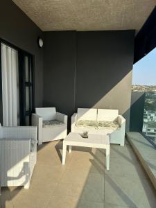 a living room with two chairs and a table at Oceans Lux 1 Bedroom - Seaview in Durban
