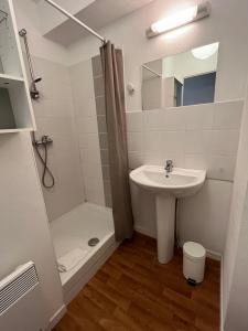 a small bathroom with a sink and a shower at Acajou YourHostHelper in Caen