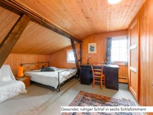 um quarto com uma cama e uma secretária num quarto em Chalet Müsli em Wildhaus