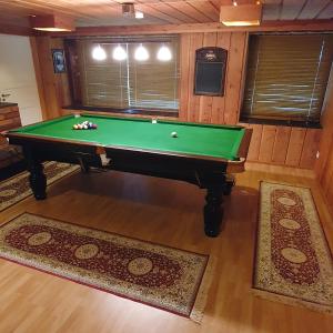 an overhead view of a pool table in a room with rugs at Villa Talo in Rovaniemi