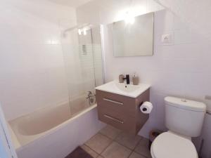 a bathroom with a toilet and a shower and a sink at Mas La belle Ambroise - Chambres d'hôtes et Gîte in Saint-Ambroix