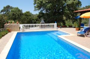 a swimming pool with a white fence around it at Casa dos Amigos-cottage for 6 persons in Estói