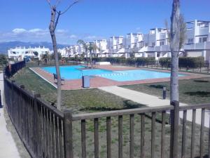 une piscine en face d'un bâtiment dans l'établissement Naranjos Condado, à Alhama de Murcia