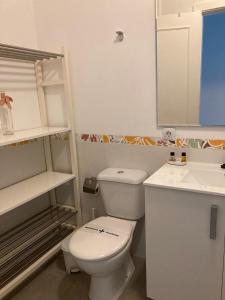 a bathroom with a white toilet and a sink at Radazul Vibes by Agüita Salada Suites in Radazul