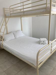 a bedroom with a bunk bed with white sheets at Exyca Radazul in Radazul