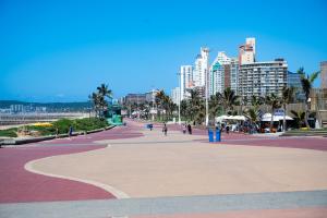a city street with tall buildings in the background at Stunning 902 Florida Road in Durban