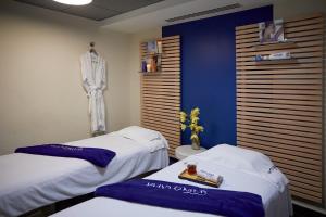 two beds in a room with blue and white at Royal Antibes - Luxury Hotel, Résidence, Beach & Spa in Antibes