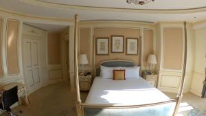 a bedroom with a white bed with a canopy at Westgate in Las Vegas