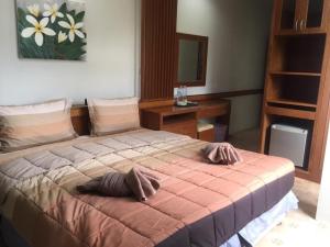 Postel nebo postele na pokoji v ubytování Praew Guesthouse