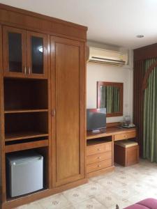 um quarto com uma secretária e um armário com um computador em Praew Guesthouse em Phra Ae beach