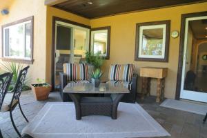 a living room with a table and a couch at Cottage On The Greens - Studio in Poway