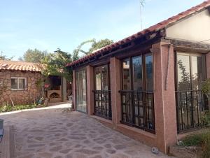 a house with glass doors and a patio at casa rural El Burrillo in Cuenca